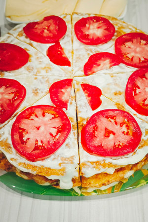 Liver cake close-up, decorated with fresh sliced tomatoes. Vertical photo.の写真素材