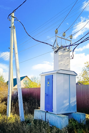 Electric power transformer and power lines poles. Vertical photography.の写真素材