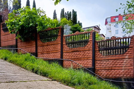 Hard long solid rural fence made from brown bricks.の写真素材