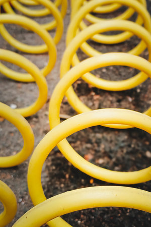 Yellow spiral hose lies on the ground.の写真素材