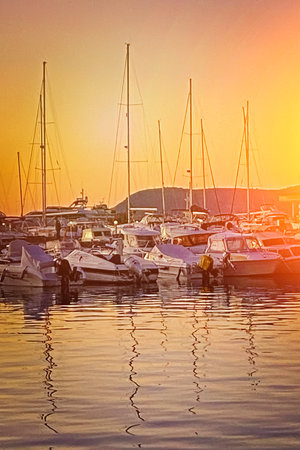 scenic small marina under the mountains in the light of the sunset, Italy. Beautiful view, Vertical photo.の写真素材