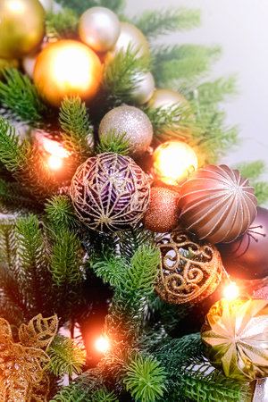 Close-up view of a Christmas tree background with lights. Vertical photo.の写真素材