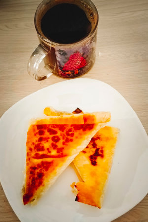 Baked stuffed pies with hot coffee. Close-up, vertical photo.の写真素材