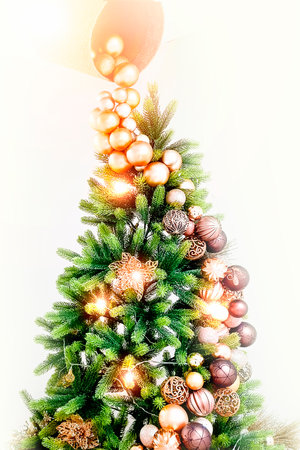 Christmas tree decorated with toys on a white background. Vertical photo.の写真素材
