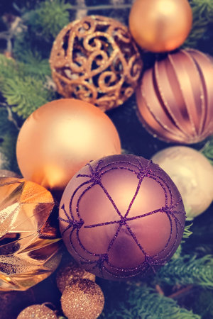 Beautiful festive decorations on the Christmas tree. Close-up. Beautiful Christmas background. The concept of decorations and decor for the new year. Vertical photo, Tinted photograph.の写真素材