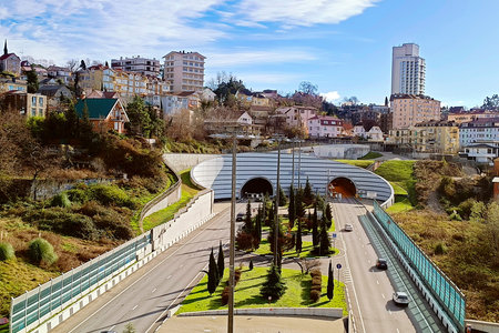 Sochi, RUSSIA - December 18, 2024: View of the city, big road, tunnel, multi-storey buildings.
