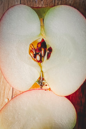 Juicy ripe apple cut in half. Close-up, vertical photo. Top view.の写真素材