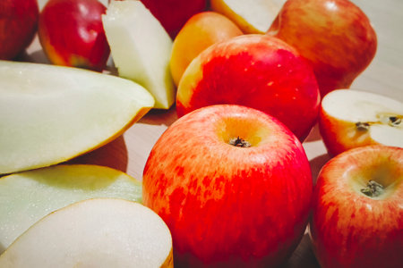 Red ripe apples and other fruits lie on the table.の写真素材