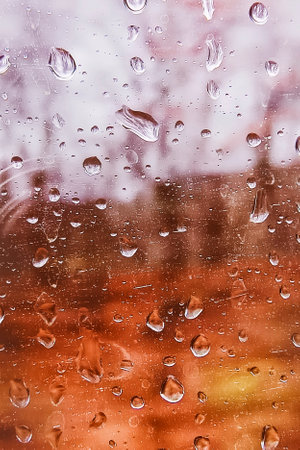 Raindrops on glass. Close-up, vertical photo.の写真素材