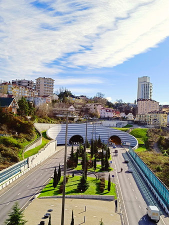 Sochi, RUSSIA - December 18, 2024: View of the city, big road, tunnel, multi-storey buildings. Vertical photo.の写真素材