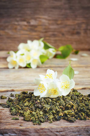 Jasmine tea on a dark wood background. の写真素材