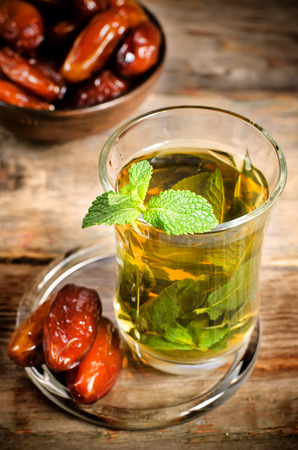 traditional turkish arabic tea with mint on the dark wood background. toning. selective focus on mintの写真素材