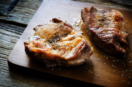 pieces of pork on a dark wood background. toning. selective focus on the middle in middle piece
