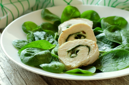 chicken rolls with spinach on a light dishの写真素材