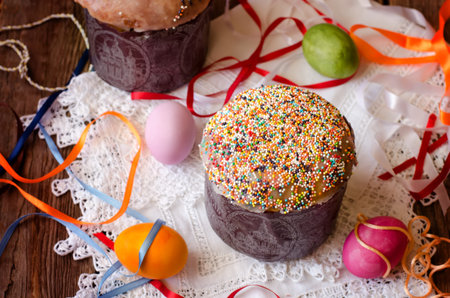 Easter cake and eggs on the white cloth with colorful ribbons