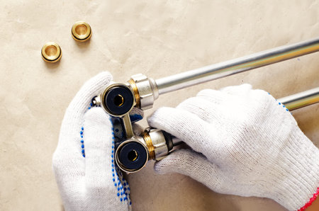 plumber at work with tools plumbing on a light woody background. tinting. selective focus