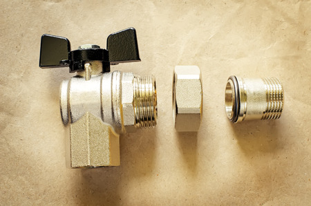angle ball valve on a light brown background. tinting. selective focusの写真素材