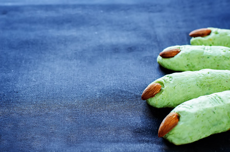 Halloween witch's fingers cookies on a dark background. tinting. selective focus on a middle biscuitsの写真素材