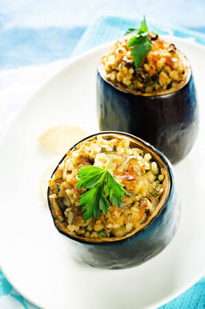 eggplant stuffed with bulgur and vegetables on a blue . tinting. selective focusの写真素材