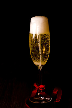 Golden glass of champagne on a dark backgroundの写真素材