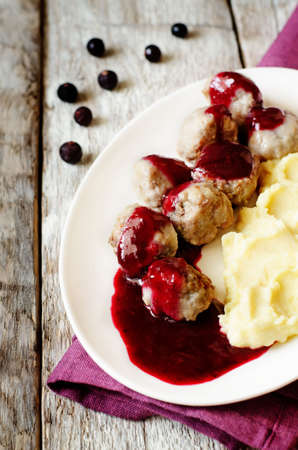 meatballs with berry sauce on a wood backgroundの写真素材