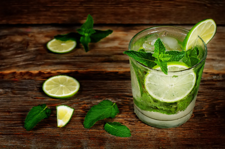 Mojito on a dark wood background. toning. selective focus on the mint in the glass.の写真素材