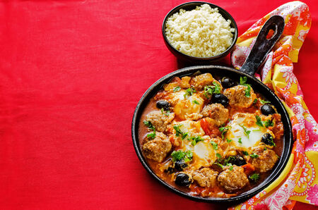 meatballs with olives and egg in tomato sauce. の写真素材