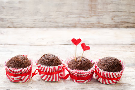 chocolate muffins on white wood background for Valentine's day. tinting. selective focus