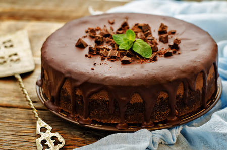 chocolate cheesecake with chocolate glaze on dark wood background. tinting. selective focusの写真素材