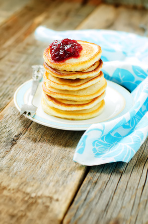 pancakes with berry jam on a dark wood background. tinting. selective focusの写真素材