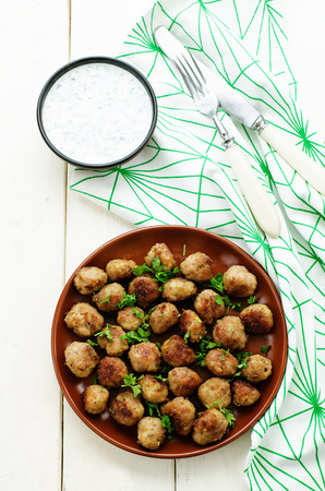 meatballs grilled with parsley on a white wood background. tinting. selective focusの写真素材