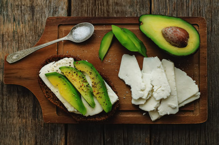 sandwich of rye bread with avocado and goat cheese. 