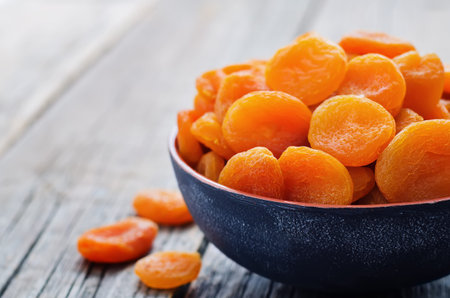 dried apricots on a dark wood background. tinting. selective focusの写真素材