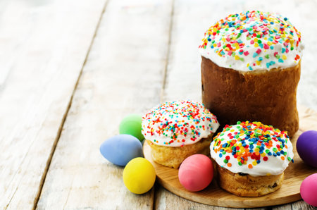 Easter cakes with colorful topping on a white wood background. tinting. selective focus