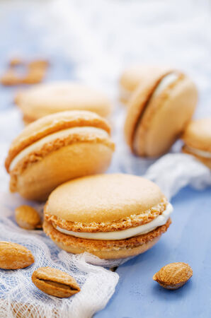 macaron with cream cheese on a bluie background. tinting. selective focusの写真素材