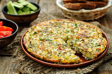 Frittata with chicken and potatoes on a dark wood background. tinting. selective focusの写真素材