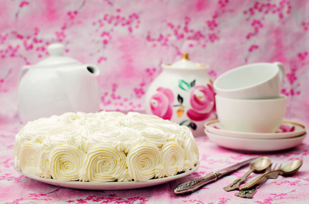 cake with vanilla cream in the form of roses on a pink background. tinting. selective focusの写真素材