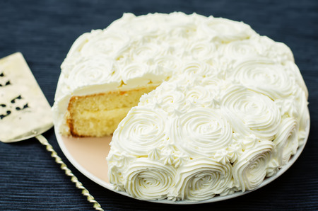 cake with vanilla cream in the form of roses on a dark background. tinting. selective focusの写真素材