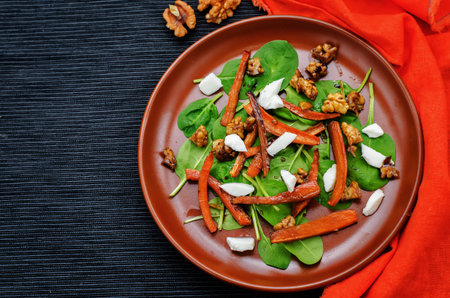 salad with spinach, mozzarella, walnuts and caramelized carrots. tinting. selective focus