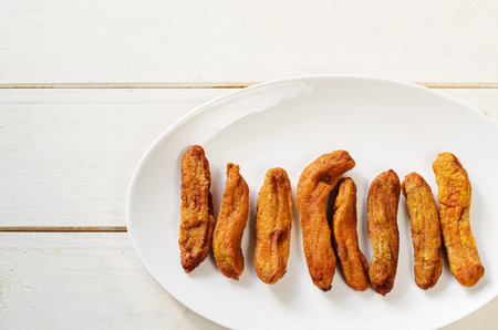 dried bananas on white wood background. tinting. selective focusの写真素材