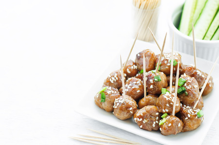 meatballs with Teriyaki sauce and sesame seeds on a white background. tinting. selective focusの写真素材