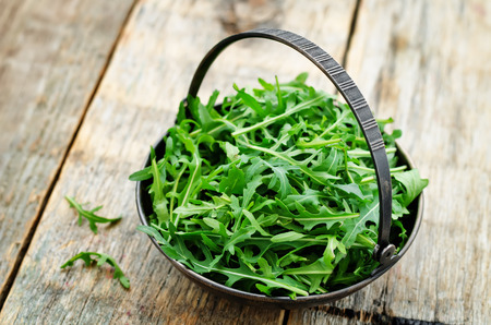 arugula on a dark wood background. toning. selective focusの写真素材