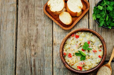 milk soup with potatoes, quinoa and peppers on a dark wood background. the toning. selective focusの写真素材
