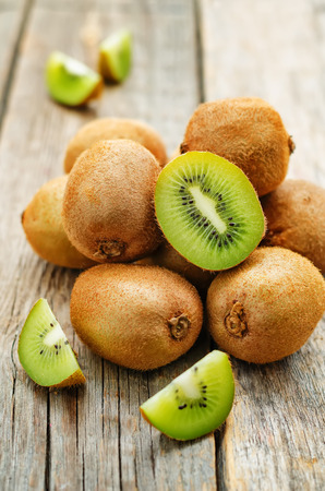 kiwi on dark wood background. tinting. selective focusの写真素材