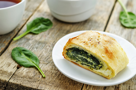 strudel with spinach and ricotta on a dark wood backgroundの写真素材