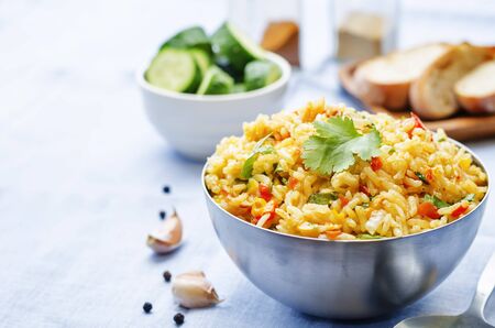 saffron rice with vegetables and cilantro on a blue backgroundの写真素材