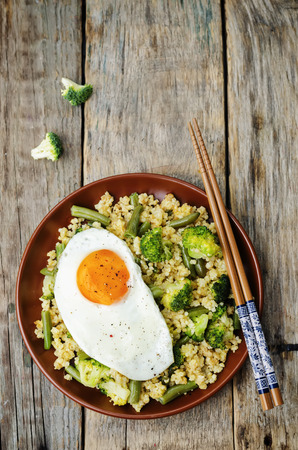 stir fried millet with broccoli, green beans and fried eggの写真素材