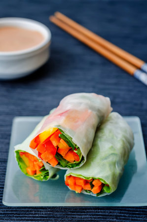 spring rolls with chili mayonnaise dressing on a black background. the toning. selective focus