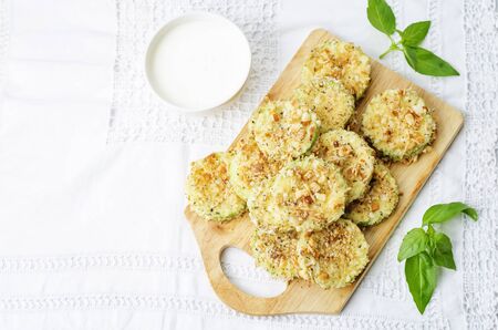 baked parmesan zucchini crisps on a white background. the toning. selective focusの写真素材