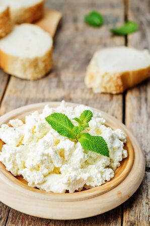 homemade ricotta with bread decorated with mint. the toning. selective focusの写真素材